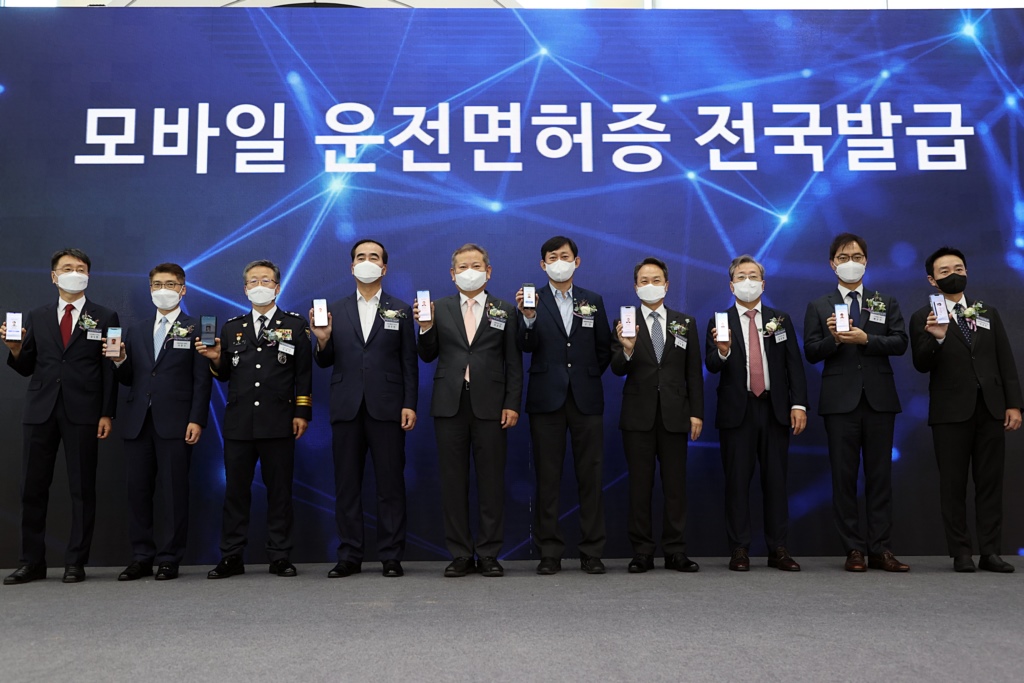 During the opening ceremony of a nationwide Mobile Driver's License issuance service held at the Gangseo Driver's License Test Center in Seoul on the morning of the 28th, officials including Interior Minister Lee Sang-min (fifth from the left) show their mobile driver's licenses.